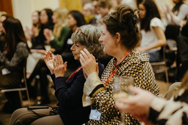 women clapping in the audience